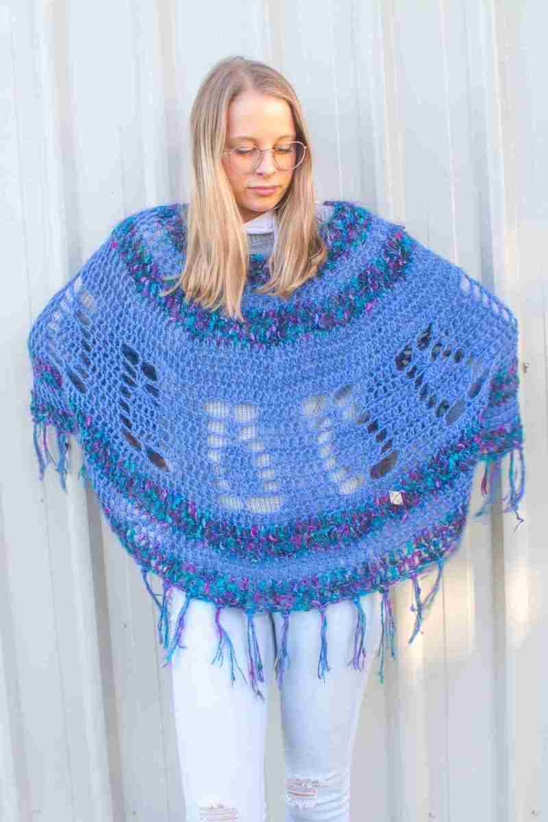 Pineapple Poncho Crochet Pattern – Blue version on Model looking down with hands on hips 2 Pineapple Poncho Crochet Pattern - Blue version on Model looking down with hands on hips 2