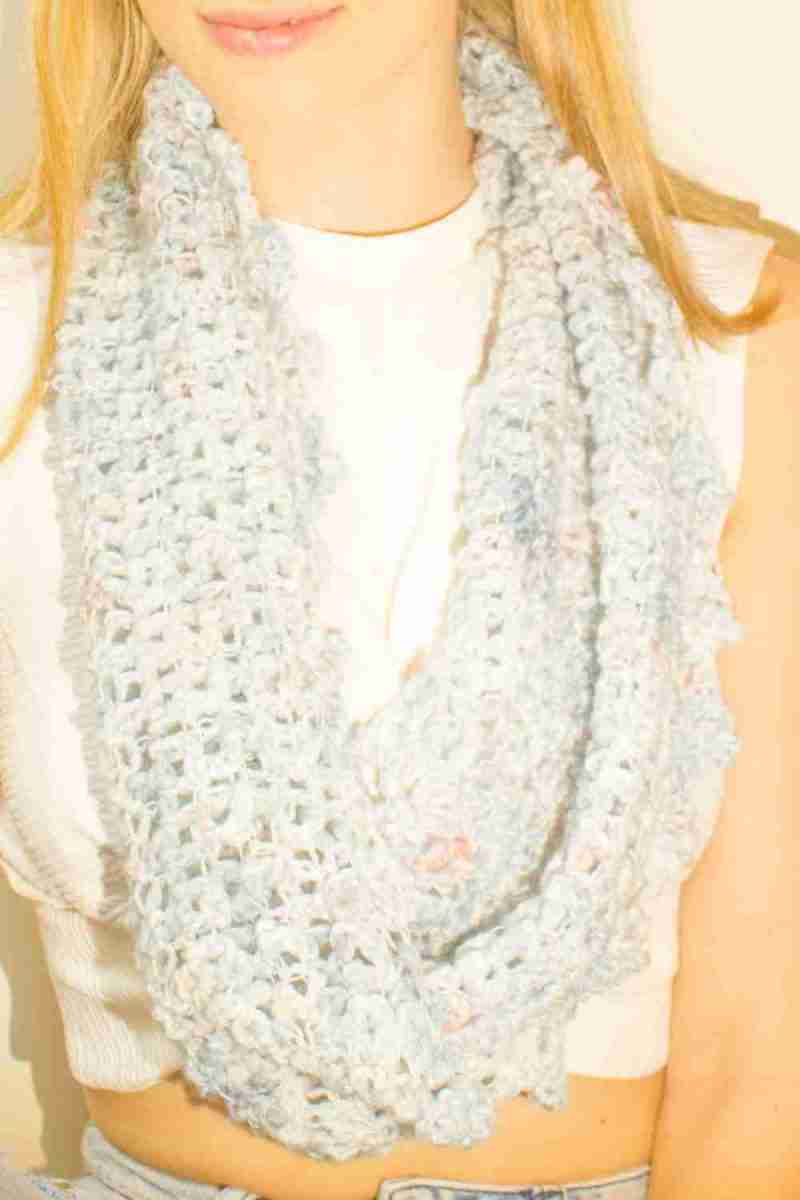 Close up of Raindrop Cowl Crochet Pattern - model looking forward - single loop around neck - in pale blue raindrops yarn