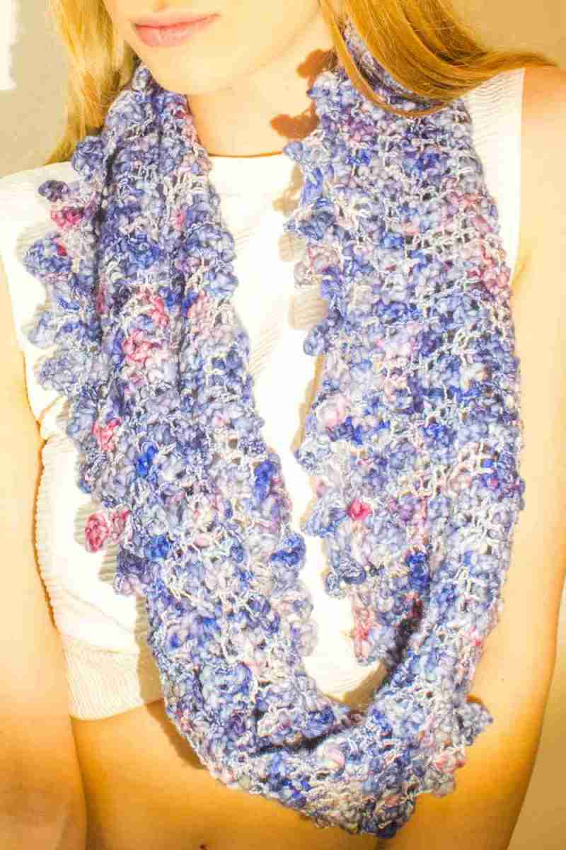 Close up of Raindrop Cowl Crochet Pattern - single loop around neck - in royal blue raindrops yarn