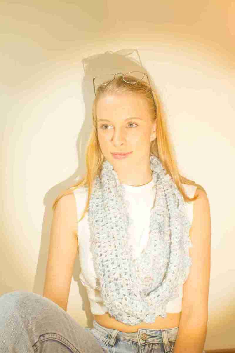 Raindrop Cowl Crochet Pattern - model looking forward - single loop around neck - in pale blue raindrops yarn
