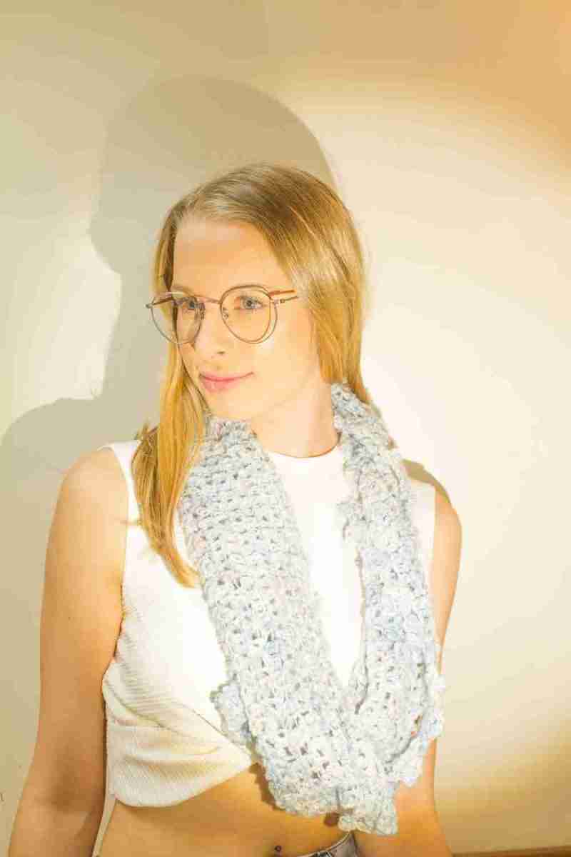 Raindrop Cowl Crochet Pattern - model looking to the side - single loop around neck - in pale blue raindrops yarn