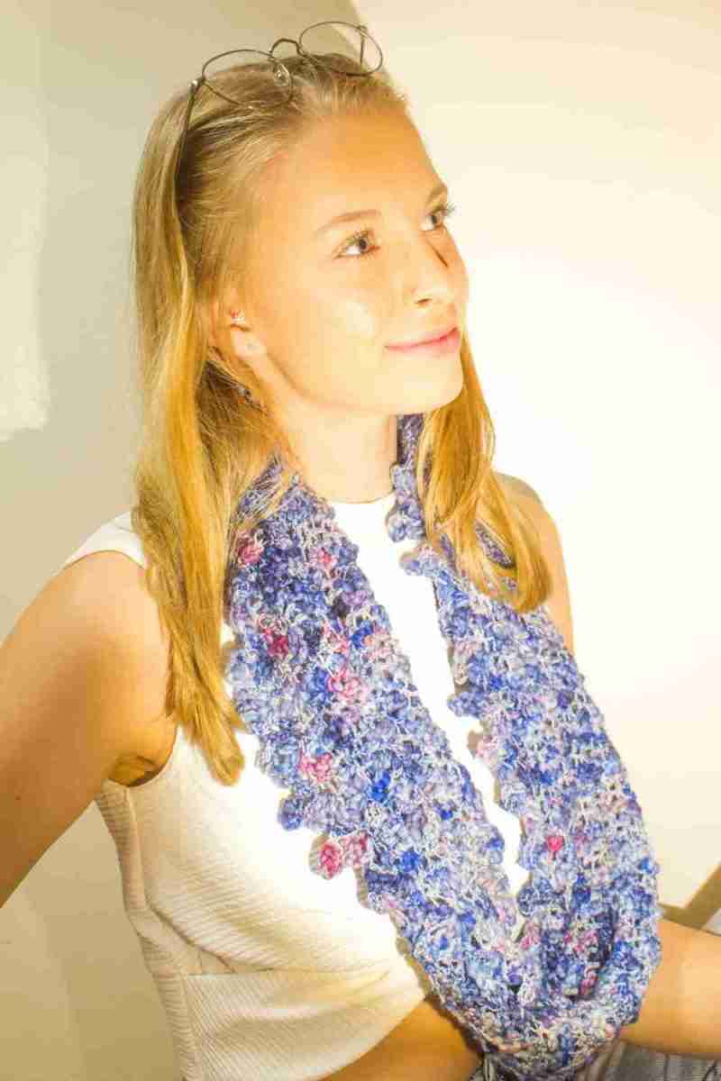 Raindrop Cowl Crochet Pattern - model looking to the side - single loop around neck - in royal blue raindrops yarn