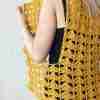 Fantail Vest Crochet Pattern by ReVe Design Co – Mustard cotton – modeled – from side – model holding front panel out Fantail Vest Crochet Pattern by ReVe Design Co - Mustard cotton - modeled - from side - model holding front panel out