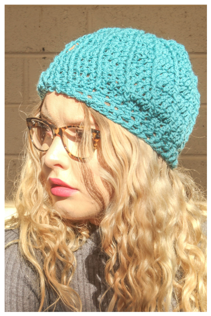 EasyFit Beanie Crochet Pattern - on a model. Side view, brim flat, in teal