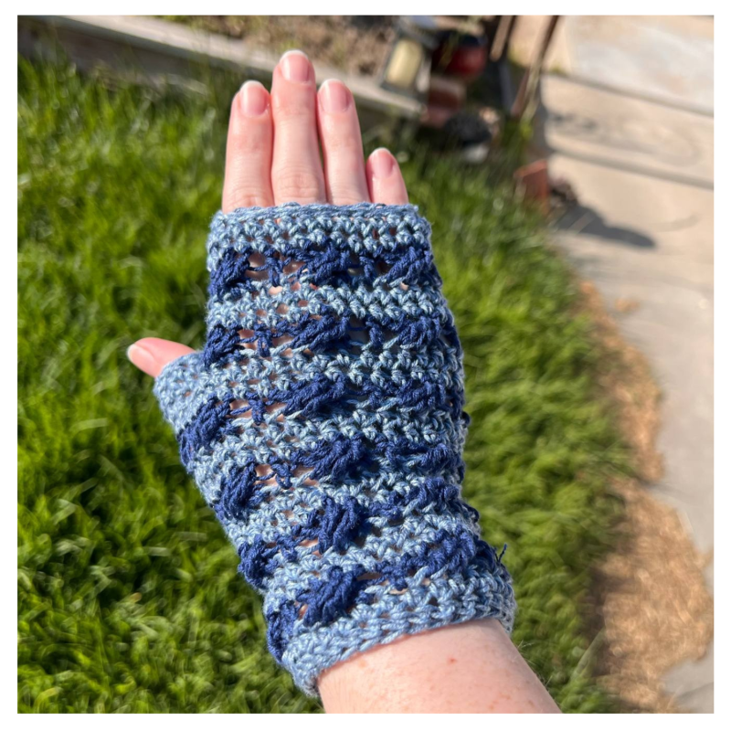 Brindy Mitts Crochet Pattern - Vanessa's version in Navy & Mid-blue - modeled on hand over grass